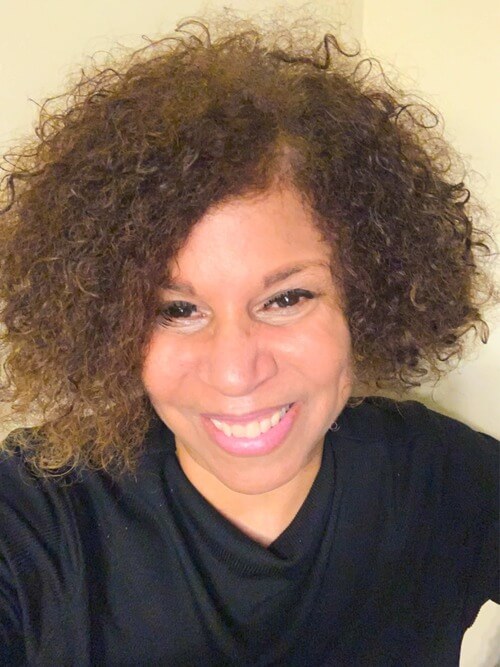 picture of woman smiling in a black shirt